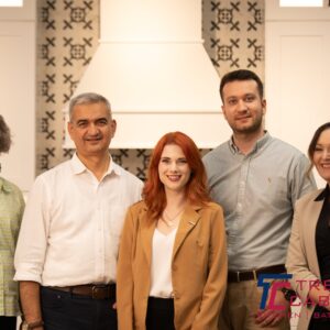 Trendy cabinet family and staff in front of kitchen cabinet showroom
